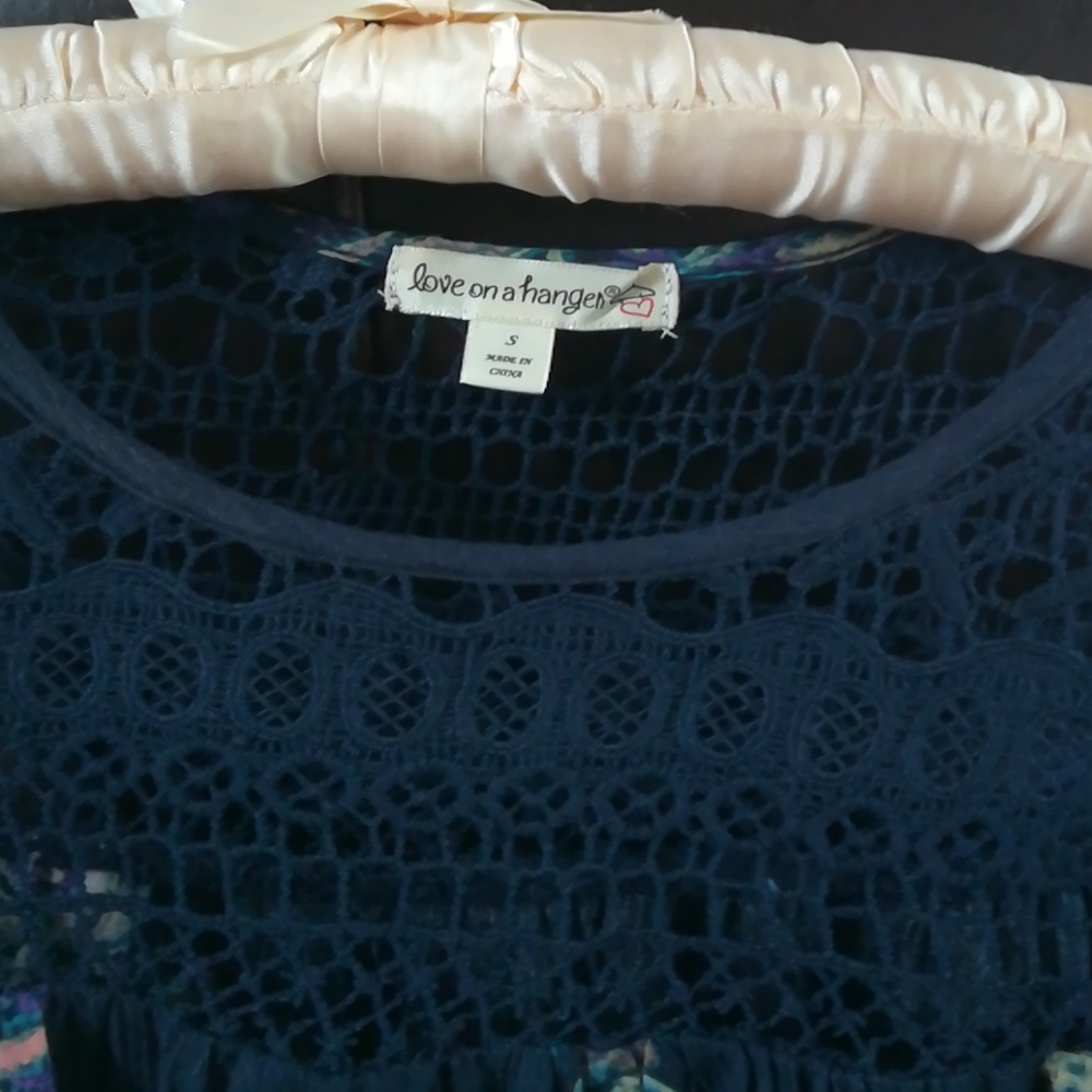 Navy blue sleeveless top with muted floral design